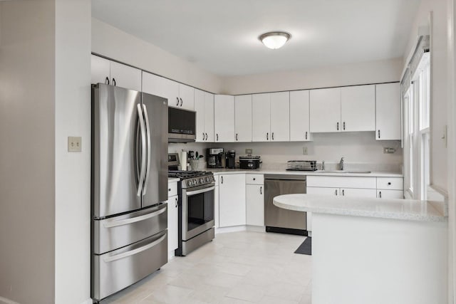 kitchen featuring white cabinets, sink, and stainless steel appliances