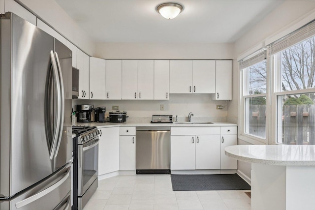 kitchen featuring white cabinetry, sink, and appliances with stainless steel finishes