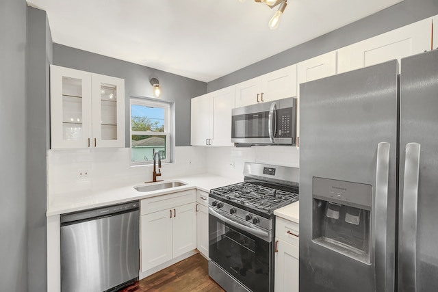 kitchen featuring white cabinets, dark hardwood / wood-style floors, sink, and appliances with stainless steel finishes