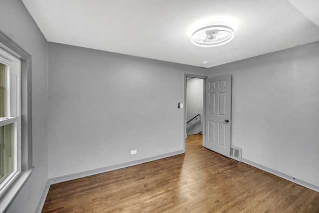 empty room with hardwood / wood-style flooring