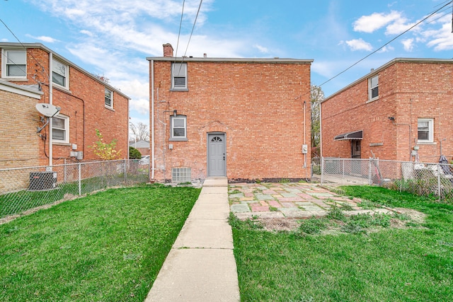 rear view of house featuring a yard and central AC unit