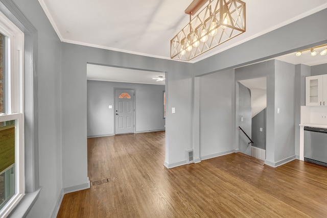 unfurnished dining area with plenty of natural light, ornamental molding, and light wood-type flooring