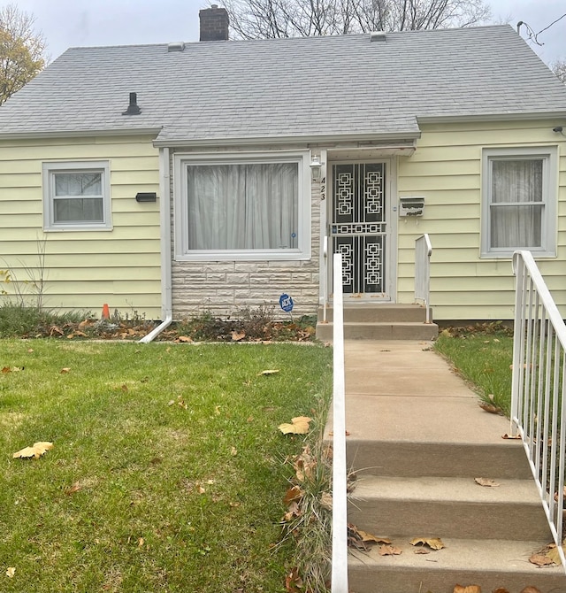 view of exterior entry with a lawn