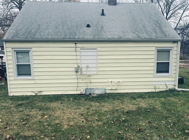 view of home's exterior with a lawn