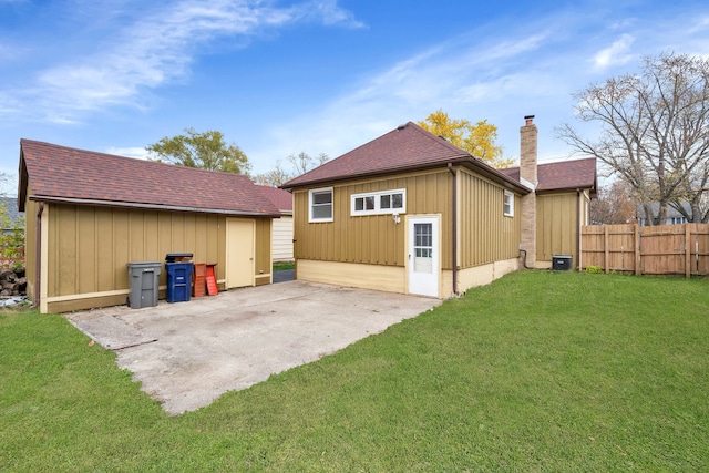 back of property featuring a lawn and a patio area