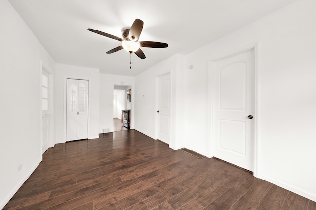 spare room with ceiling fan and dark hardwood / wood-style flooring