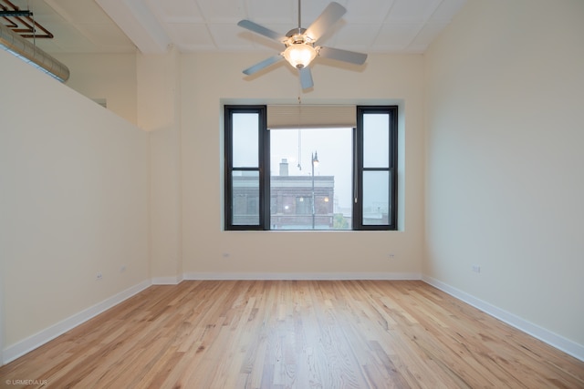 spare room featuring light hardwood / wood-style flooring and ceiling fan