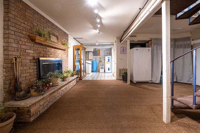 basement with carpet, white fridge, and water heater