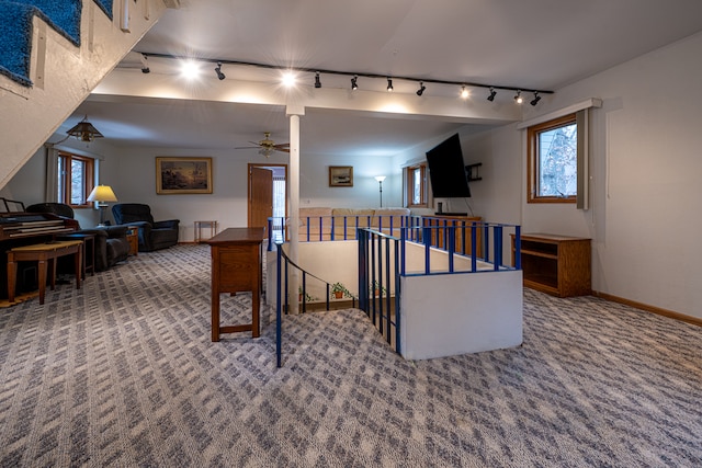 carpeted living room with ceiling fan and track lighting