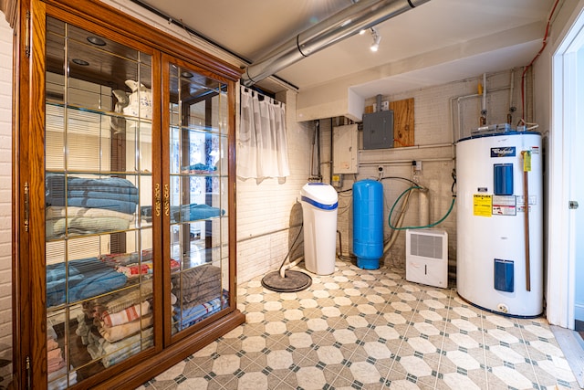 utility room featuring electric panel and water heater