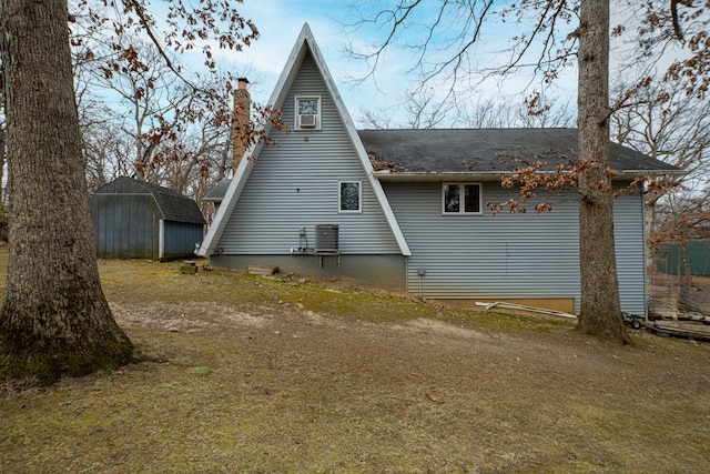 rear view of house featuring an outbuilding