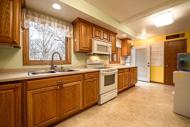 kitchen featuring white appliances and sink