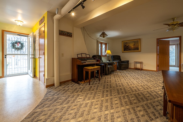 entryway with ceiling fan and rail lighting