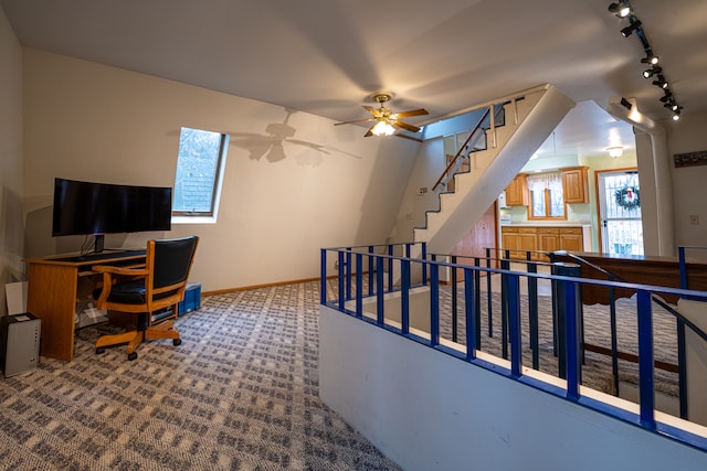 carpeted office space featuring ceiling fan and rail lighting