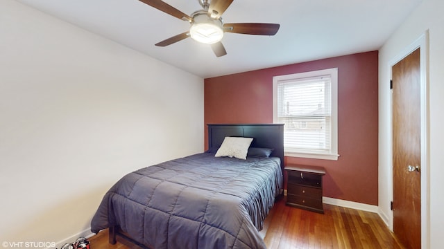 bedroom featuring hardwood / wood-style floors and ceiling fan