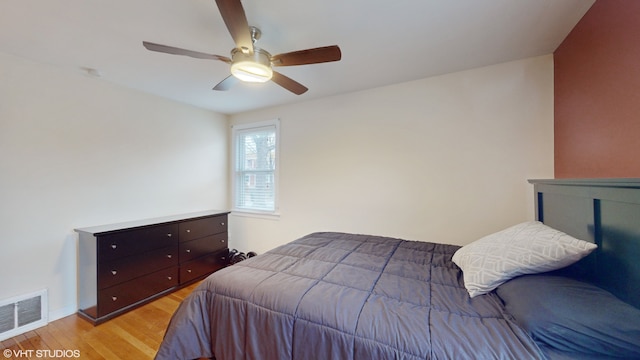 bedroom with light wood-type flooring and ceiling fan