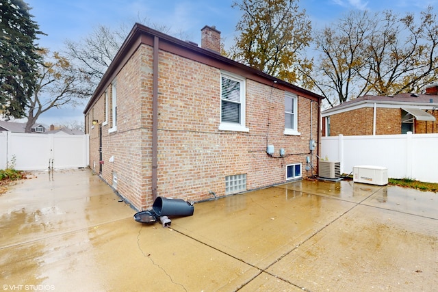 back of house featuring cooling unit and a patio area