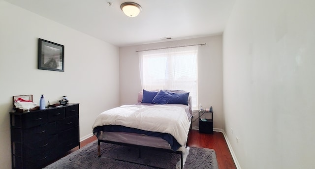 bedroom featuring dark hardwood / wood-style flooring