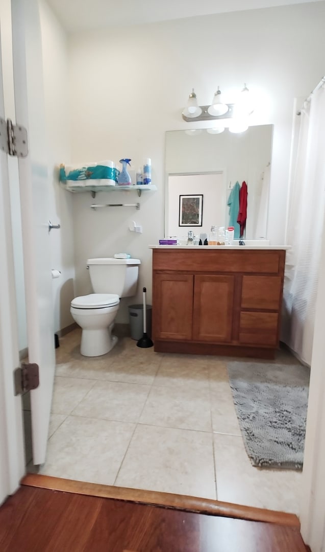 bathroom with tile patterned floors, vanity, and toilet