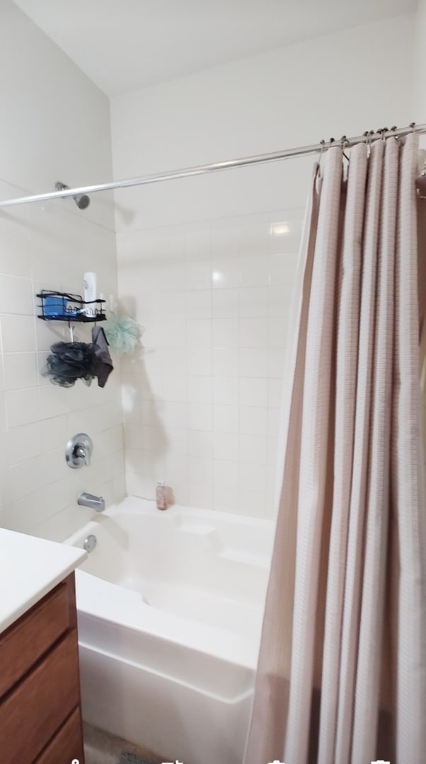 bathroom with shower / bath combination with curtain