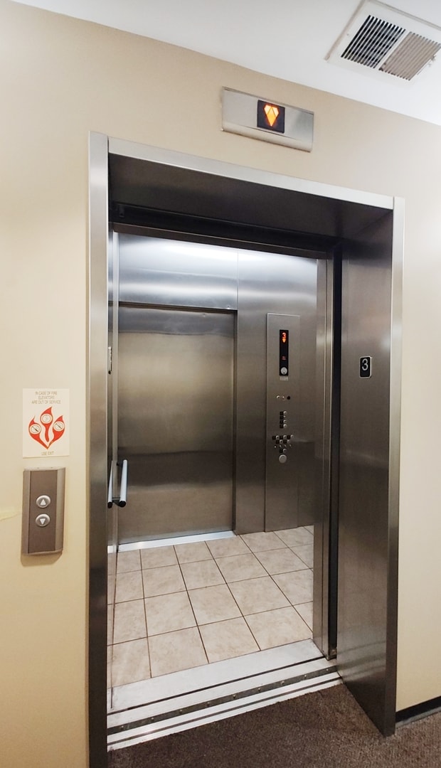 room details featuring carpet floors and elevator