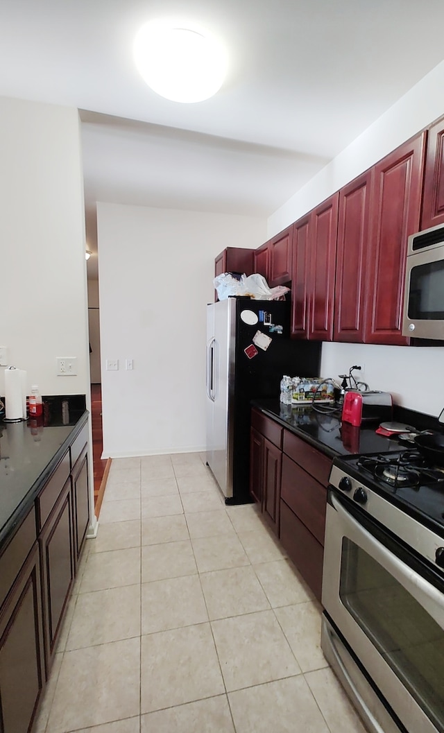 kitchen featuring light tile patterned floors and stainless steel appliances