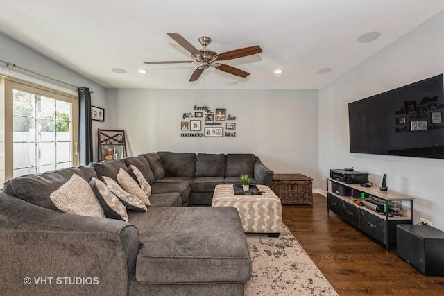 living room with ceiling fan and dark hardwood / wood-style floors