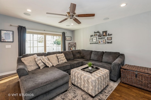 living room with ceiling fan and dark hardwood / wood-style floors