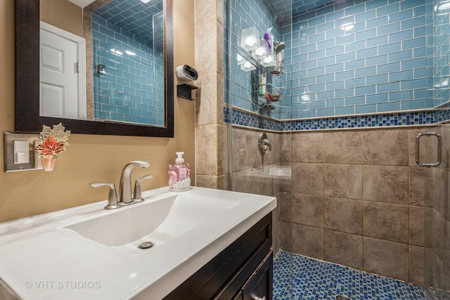 bathroom featuring vanity and a shower with door