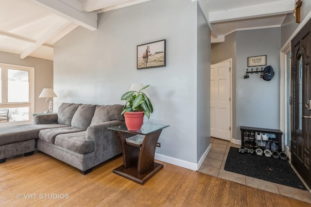 tiled living room featuring lofted ceiling with beams