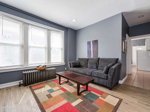 living room featuring radiator and light hardwood / wood-style flooring