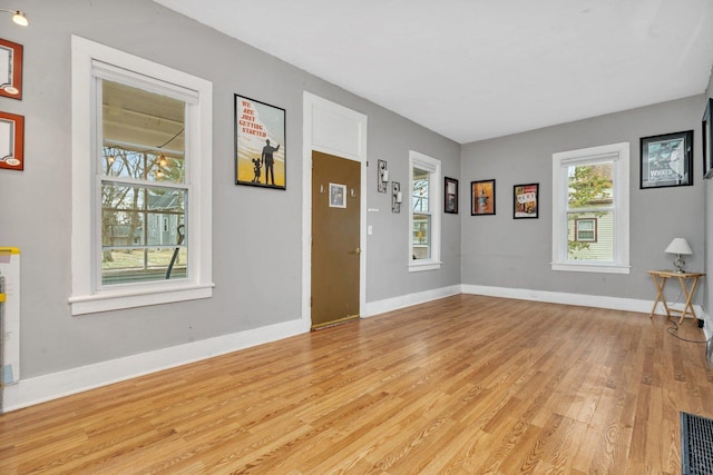 interior space with light hardwood / wood-style flooring and plenty of natural light