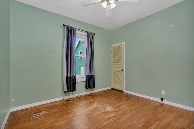 empty room with hardwood / wood-style flooring and ceiling fan