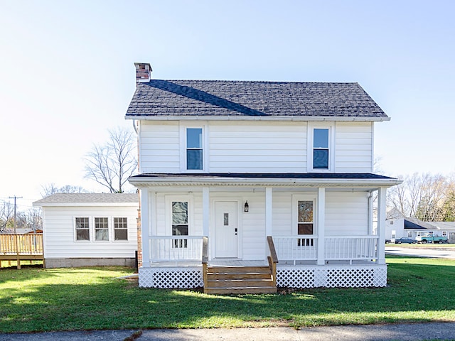 view of front of home featuring covered porch and a front yard