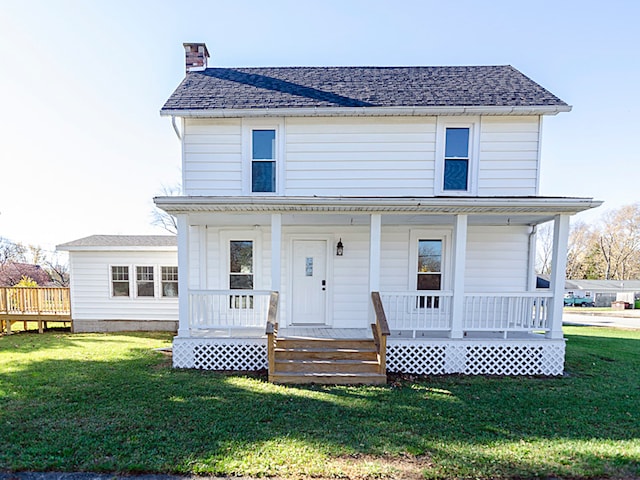 view of front of property with covered porch and a front lawn