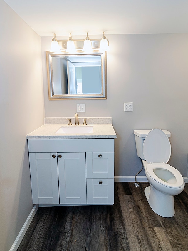 bathroom featuring vanity, hardwood / wood-style flooring, and toilet