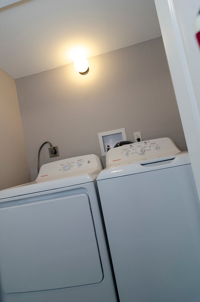 clothes washing area with separate washer and dryer