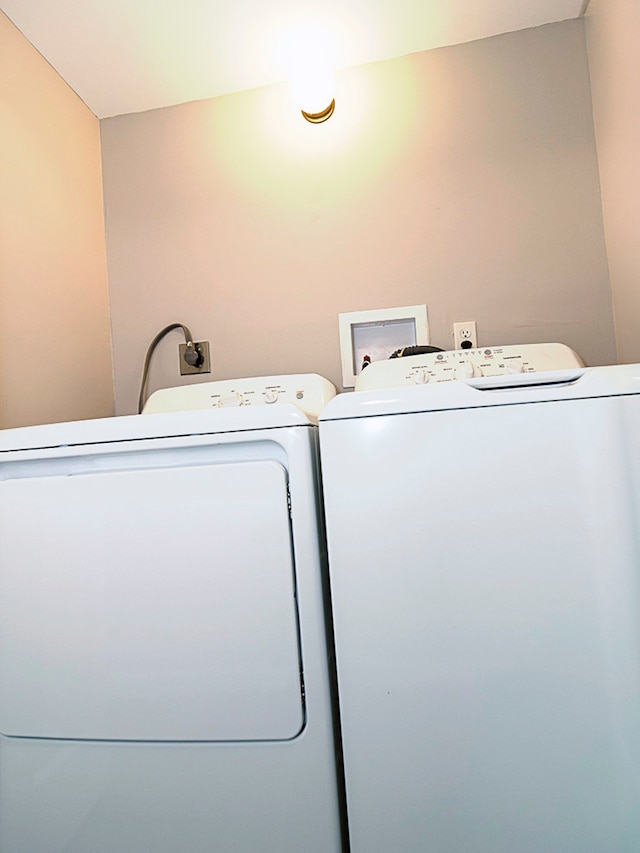 clothes washing area with washing machine and dryer