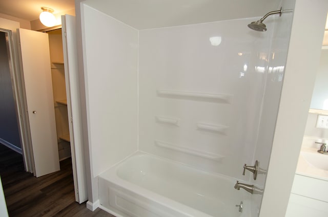 bathroom with hardwood / wood-style floors, vanity, and shower / bathtub combination