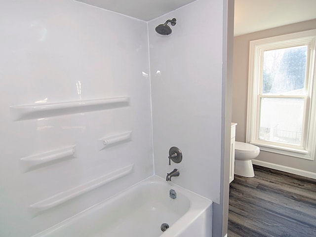 full bathroom with vanity, wood-type flooring, shower / bathtub combination, and toilet