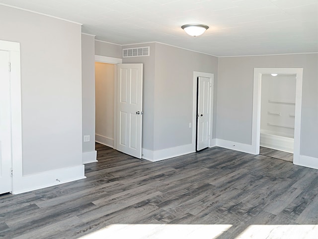 unfurnished room featuring dark hardwood / wood-style floors and crown molding