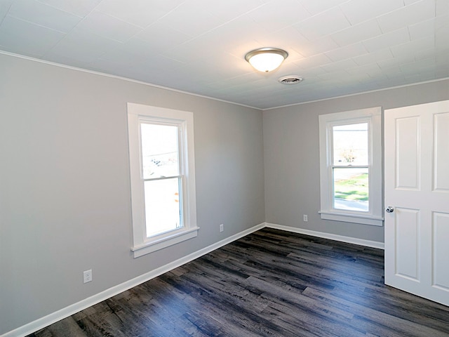 unfurnished room with crown molding and dark hardwood / wood-style floors