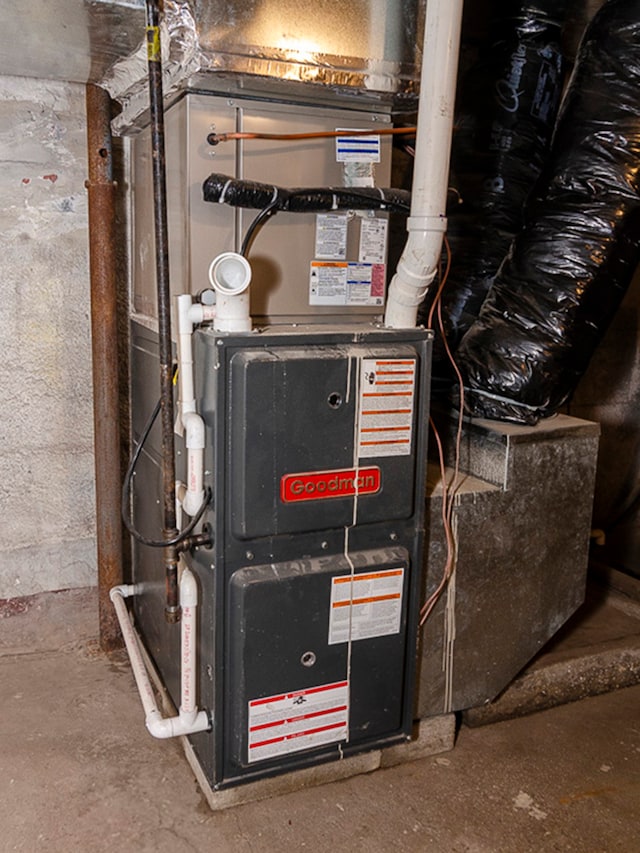 utility room featuring heating unit