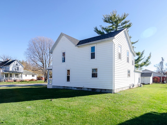 view of side of home featuring a yard