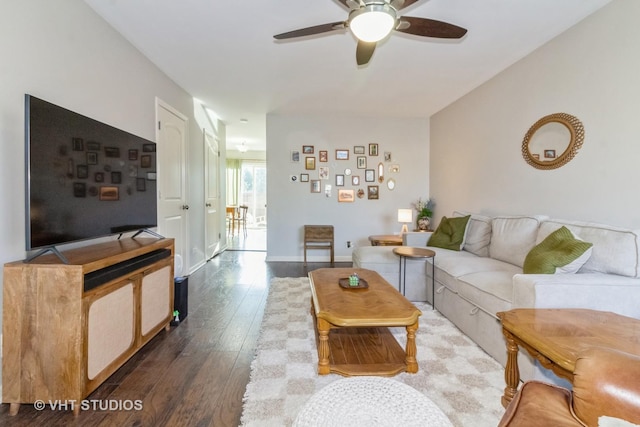 living room with ceiling fan and dark hardwood / wood-style flooring