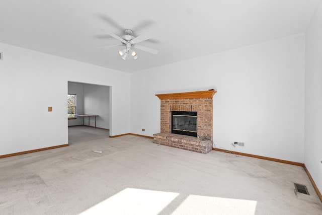 unfurnished living room with carpet, a fireplace, visible vents, and baseboards