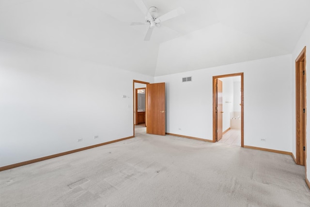 unfurnished bedroom featuring light colored carpet, visible vents, vaulted ceiling, ensuite bath, and baseboards