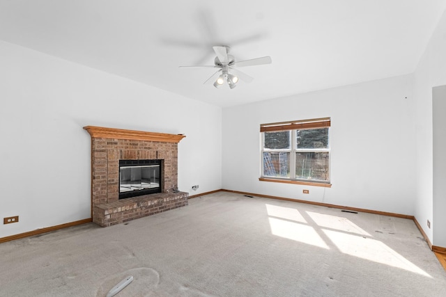 unfurnished living room featuring carpet, ceiling fan, a fireplace, and baseboards