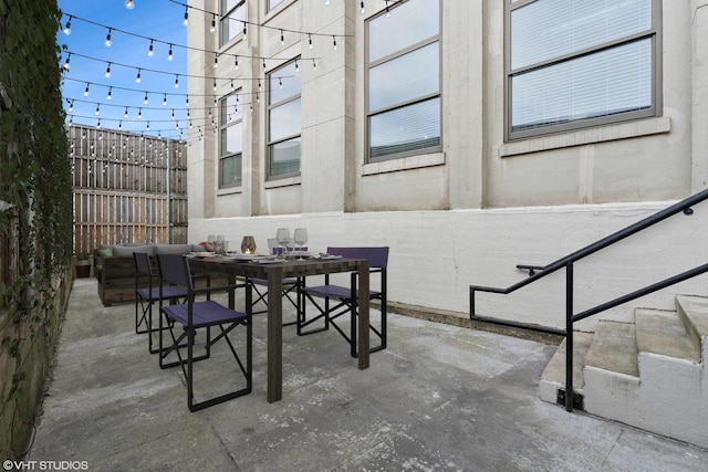 view of patio / terrace featuring fence and outdoor dining area