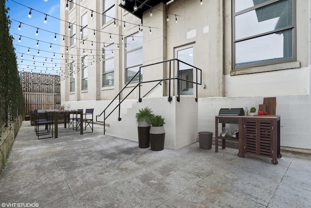 view of patio featuring fence and outdoor dining area